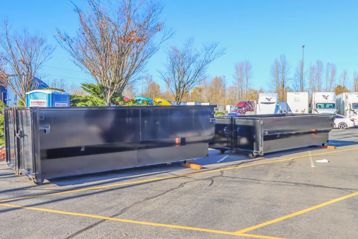 Professional dumpster rental service with roll-off container on residential driveway in Godley